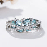 Bague avec croix et pierre précieuse bleue | Or blanc