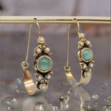 Boucles d'oreilles au style ethno-rétro avec pendentif | Or
