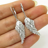 Boucles d'oreilles avec des ailes scintillantes | Or blanc