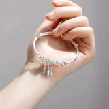 Bracelet ajustable avec médaille à trois feuilles | Or blanc