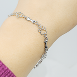 Bracelet avec pattes de chien suspendues et Os Brut, Édition limitée | Or blanc