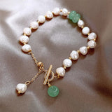 Bracelet rétro avec des marguerites et des pierres précieuses vertes | Or