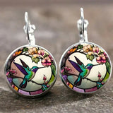 Collier avec pendentif en métal en forme d'hirondelle avec dôme en verre | Or