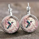 Collier avec pendentif en métal en forme d'hirondelle avec dôme en verre | Or
