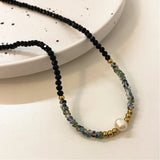Collier avec perles noires, or et perles | Or